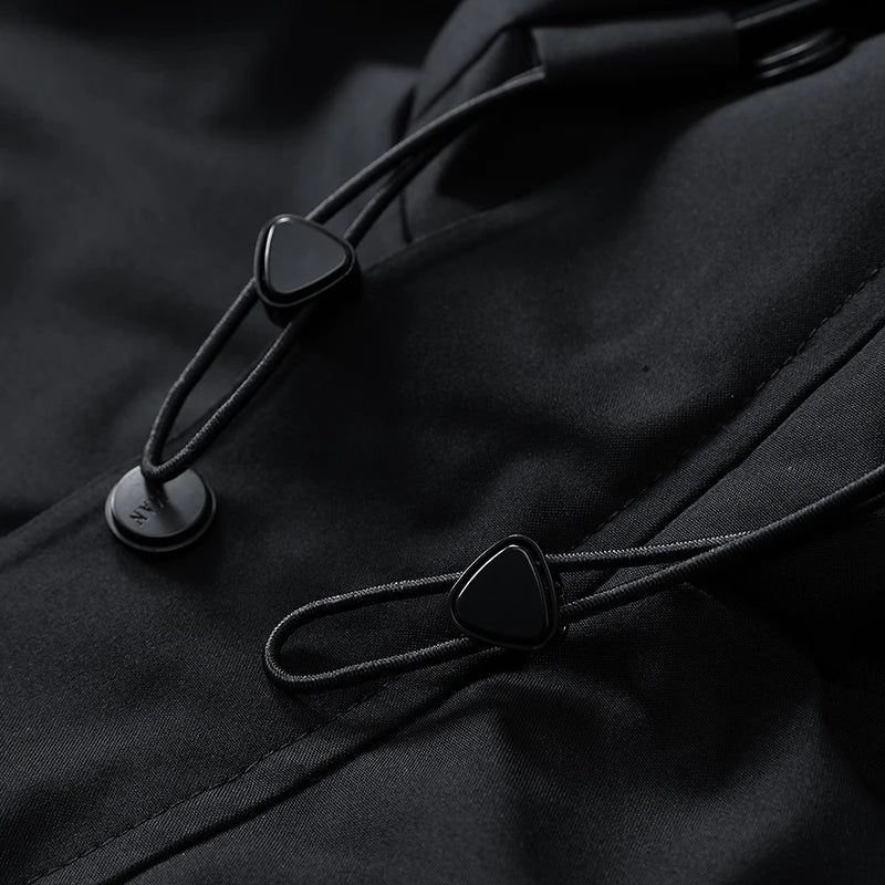 Close-up of black buttons on a dark fabric surface