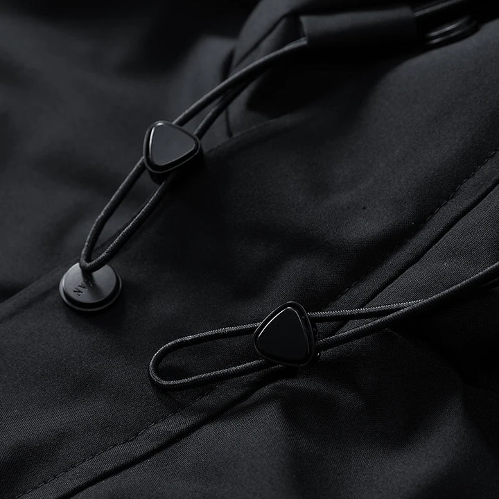 Close-up of black buttons on a dark fabric surface