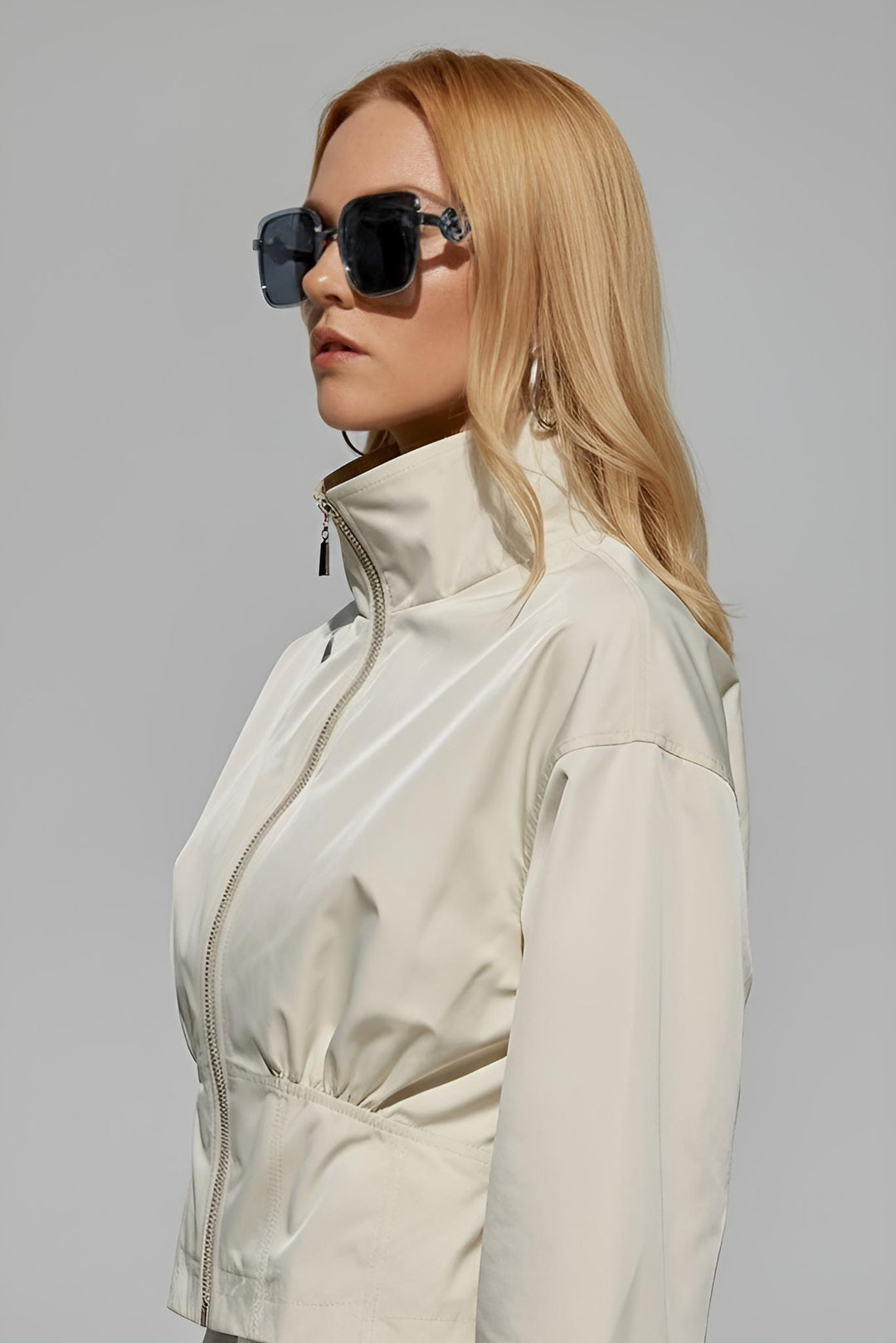 Close-up portrait of model wearing MAELIN beige jacket with sunglasses