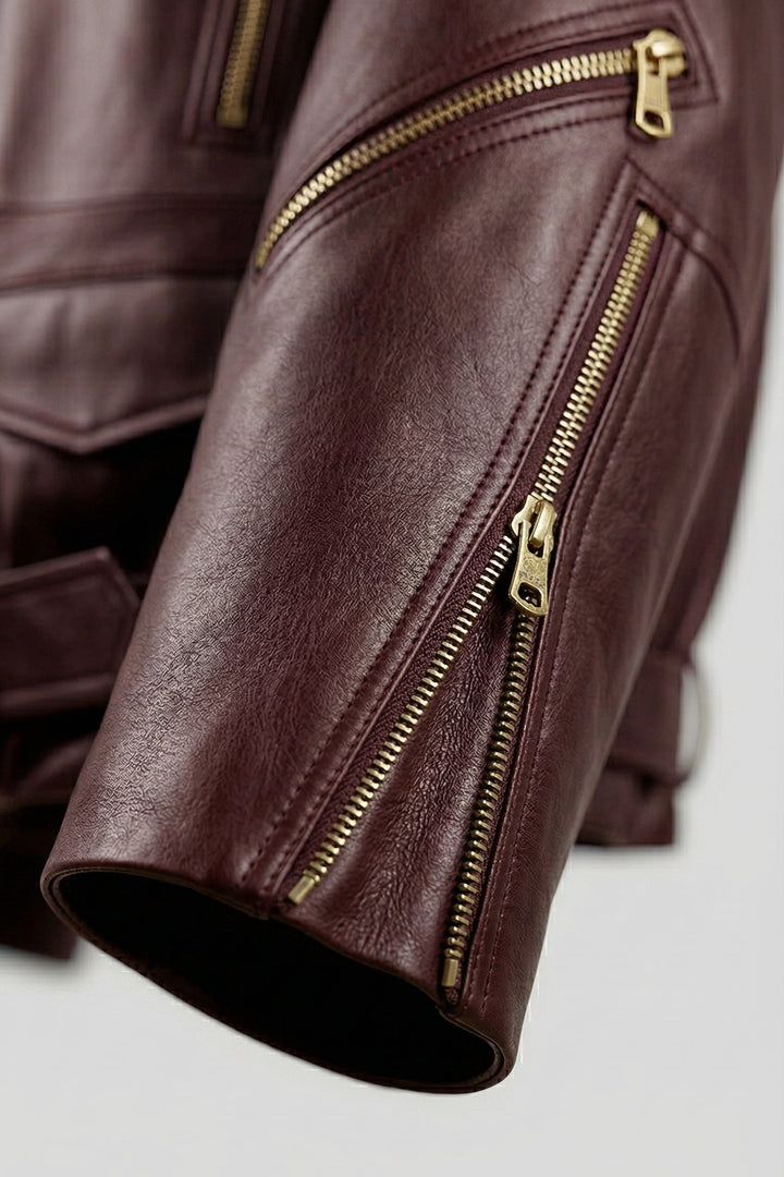 DELILAH - Detail shot of burgundy leather jacket sleeve zippers