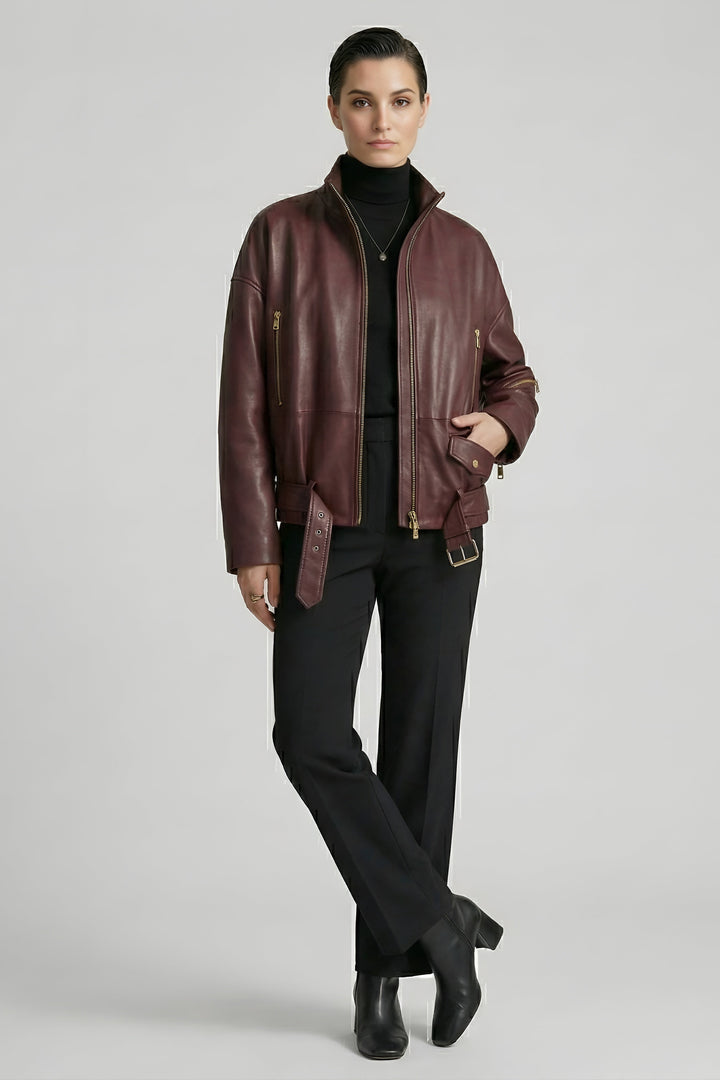 DELILAH - Full body shot of model in burgundy leather jacket and black pants