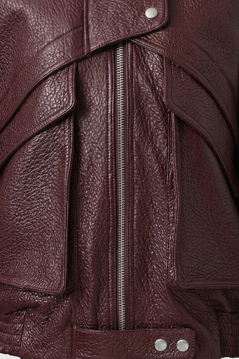 DREW - Close-up of a brown leather jacket with a zipper