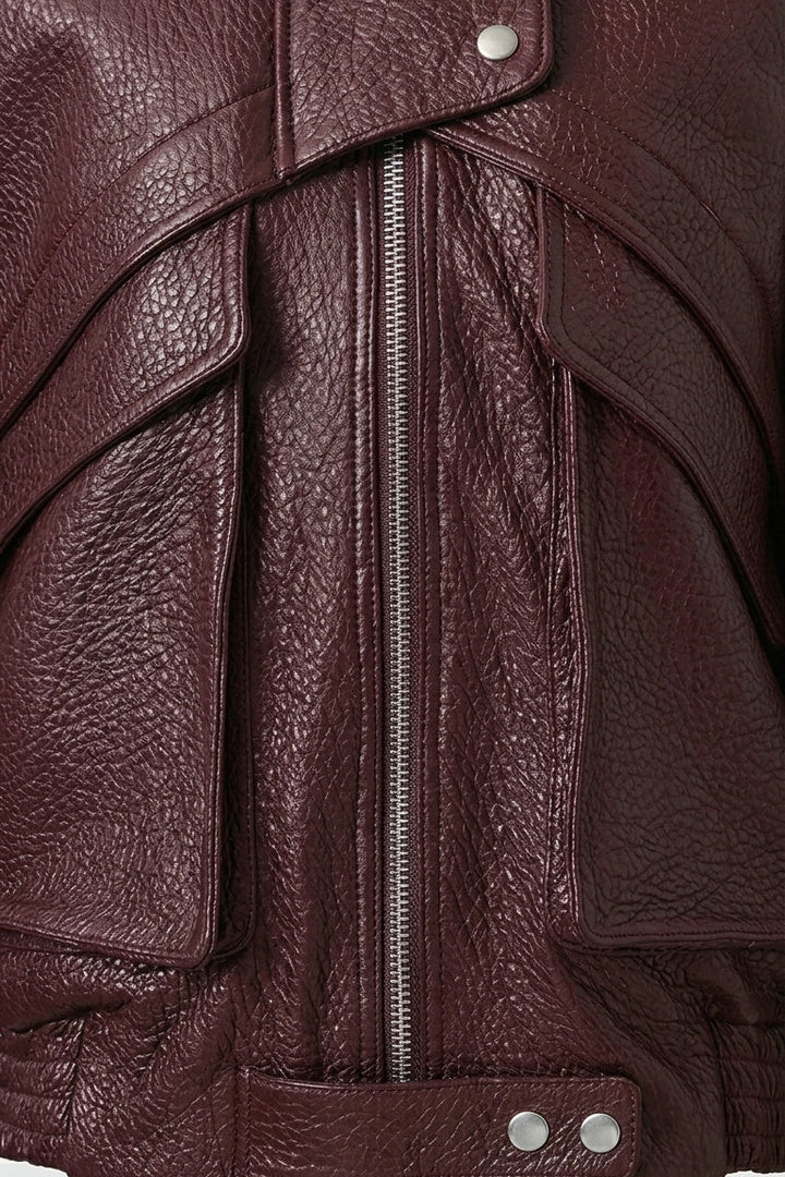 DREW - Close-up of a brown leather jacket with a zipper