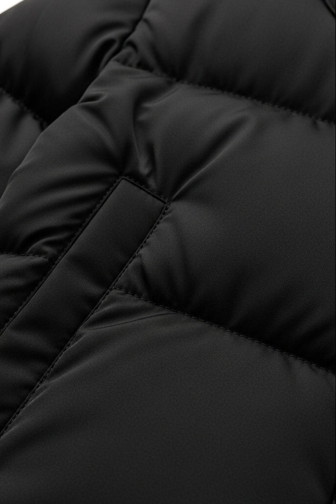Close-up of a black puffer jacket with quilted texture