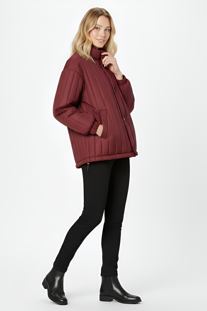 Discover the NARVINA lightweight puffer jacket for women, crafted with breathable duck-down warmth, a clean stand collar, and minimalist quilted design.