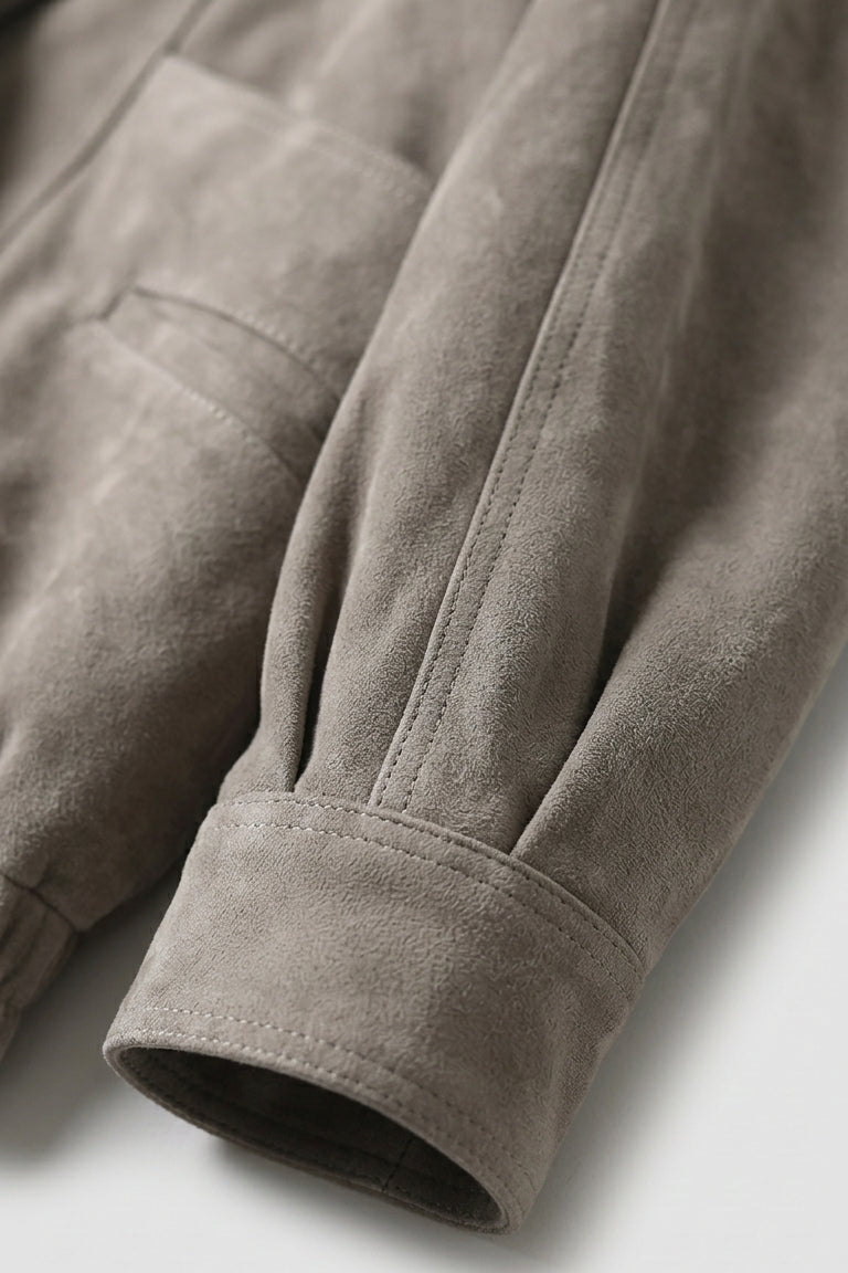 ELISE - Close-up of a brown jacket with a pocket on a light gray background