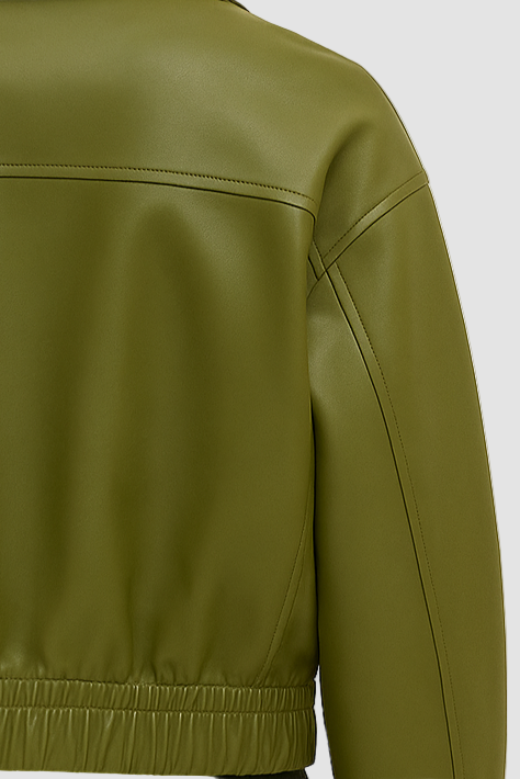 Green leather jacket worn by a person on a beige background