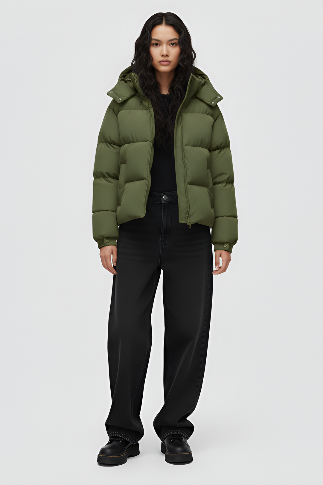 Green puffer jacket with a hood on a white background