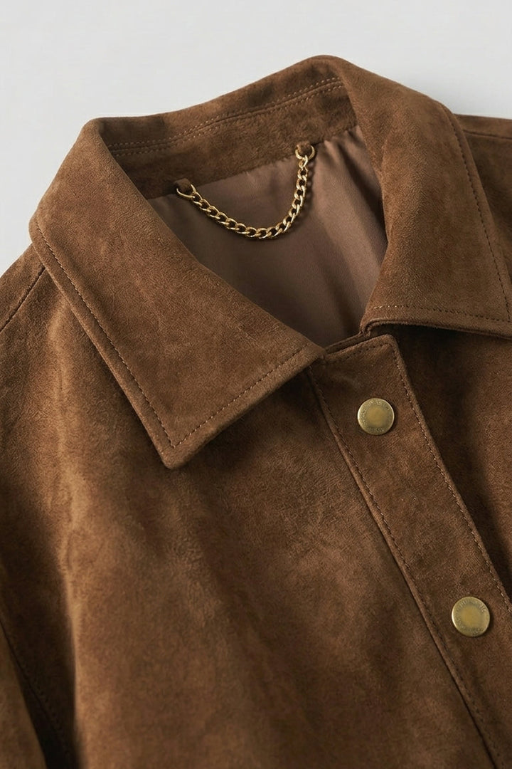 KENDALL - Close-up of brown suede jacket collar and chain detail