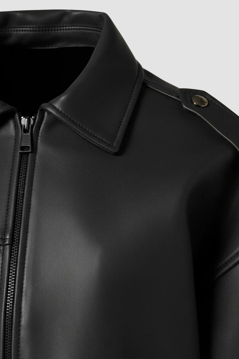 HOLLIS - Black faux leather motorcycle jacket, close-up of collar and zipper