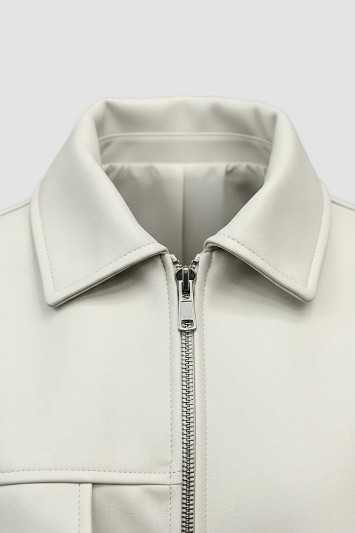 HOLLIS - Close-up of cream faux leather jacket collar and zipper