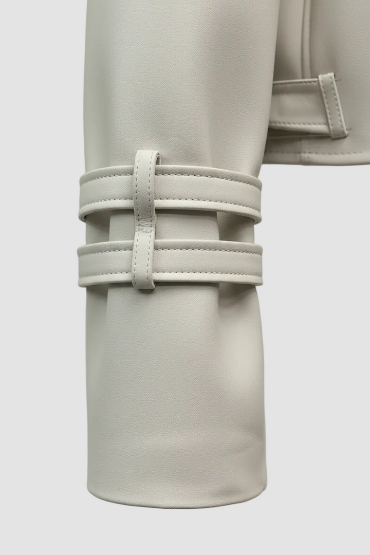 HOLLIS - Detail of cream faux leather jacket cuff with buckle straps