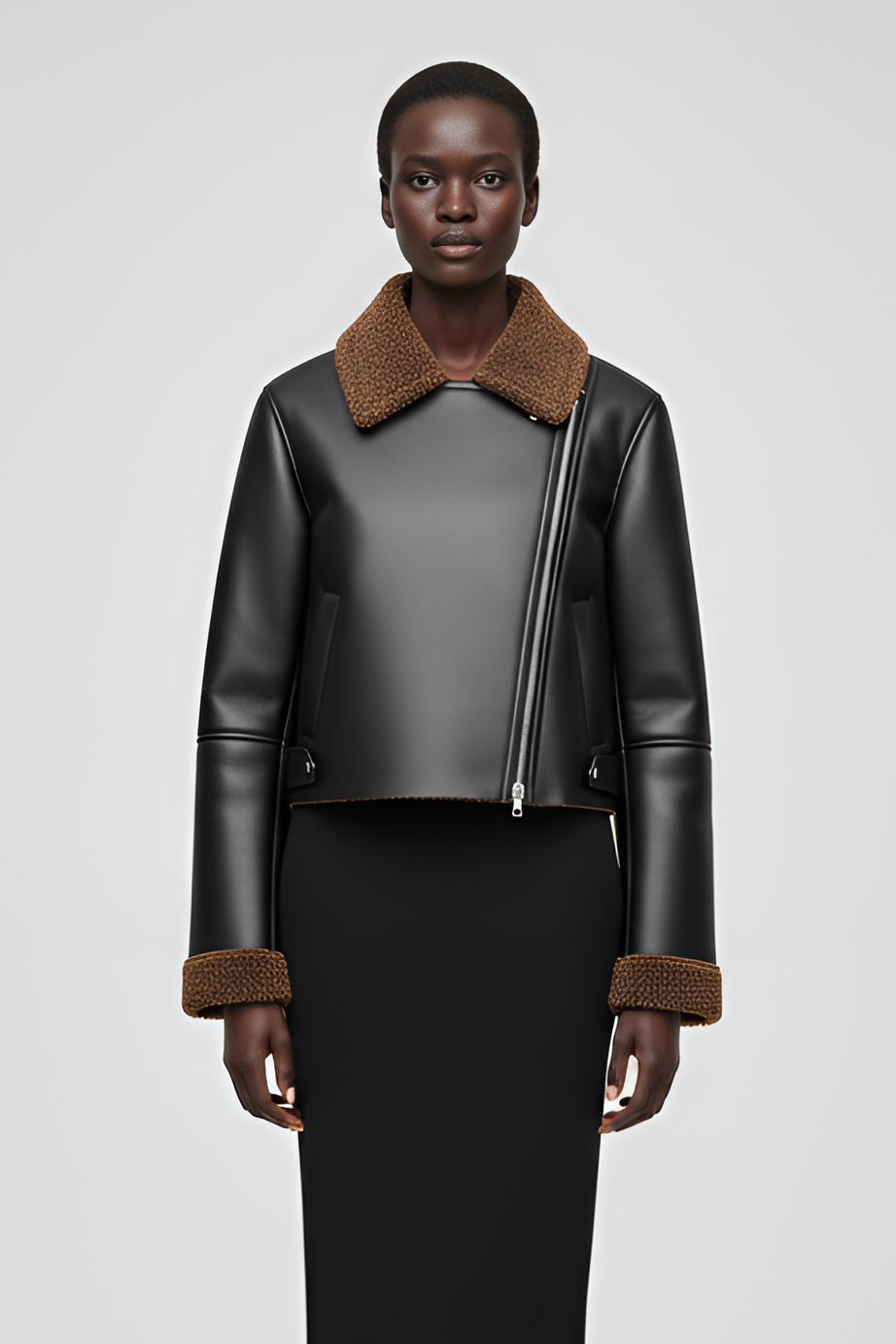 High-waist motorcycle-style faux leather jacket with textured fleece collar.