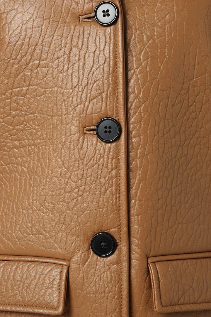 LANE - Bubble Leather Coat, detail of black buttons on brown leather