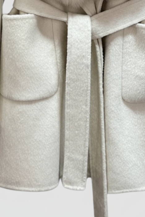 Light gray coat with fur collar on a light gray background