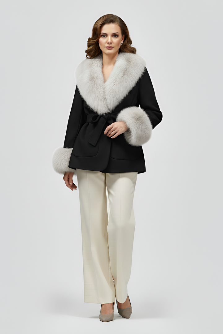 Luxury black faux fur belted coat for women with light faux fur collar and cuffs, elegant winter outfit worn with cream trousers, premium studio fashion photography