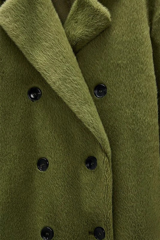Green coat with black buttons on a white background