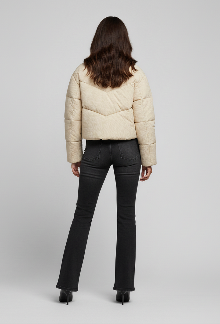 MCKENNA - Woman in cream puffer jacket, back view , posed
