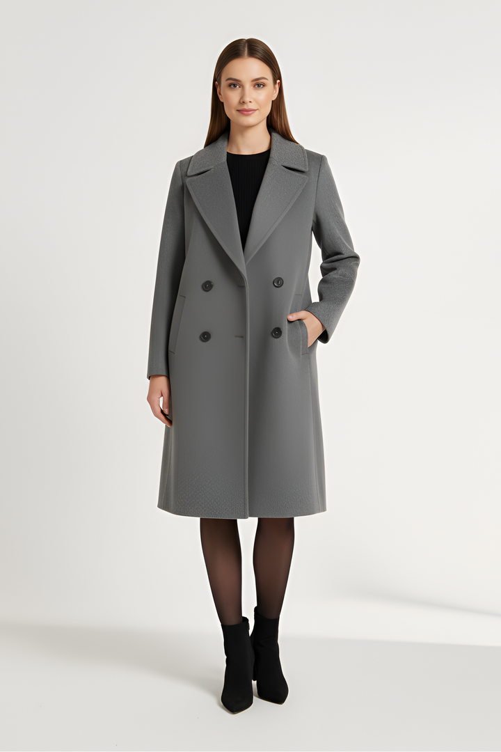 Woman wearing a gray coat on a white background