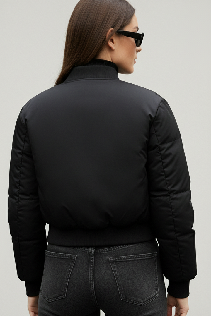 Model styling CAELIA Oversized Bomber Jacket for a modern urban winter streetwear look.