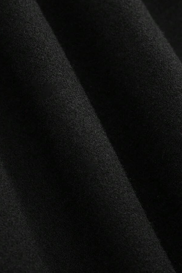 Model styling LEONA Wool Blend Long Coat with chic all-black outfit for modern elegance.