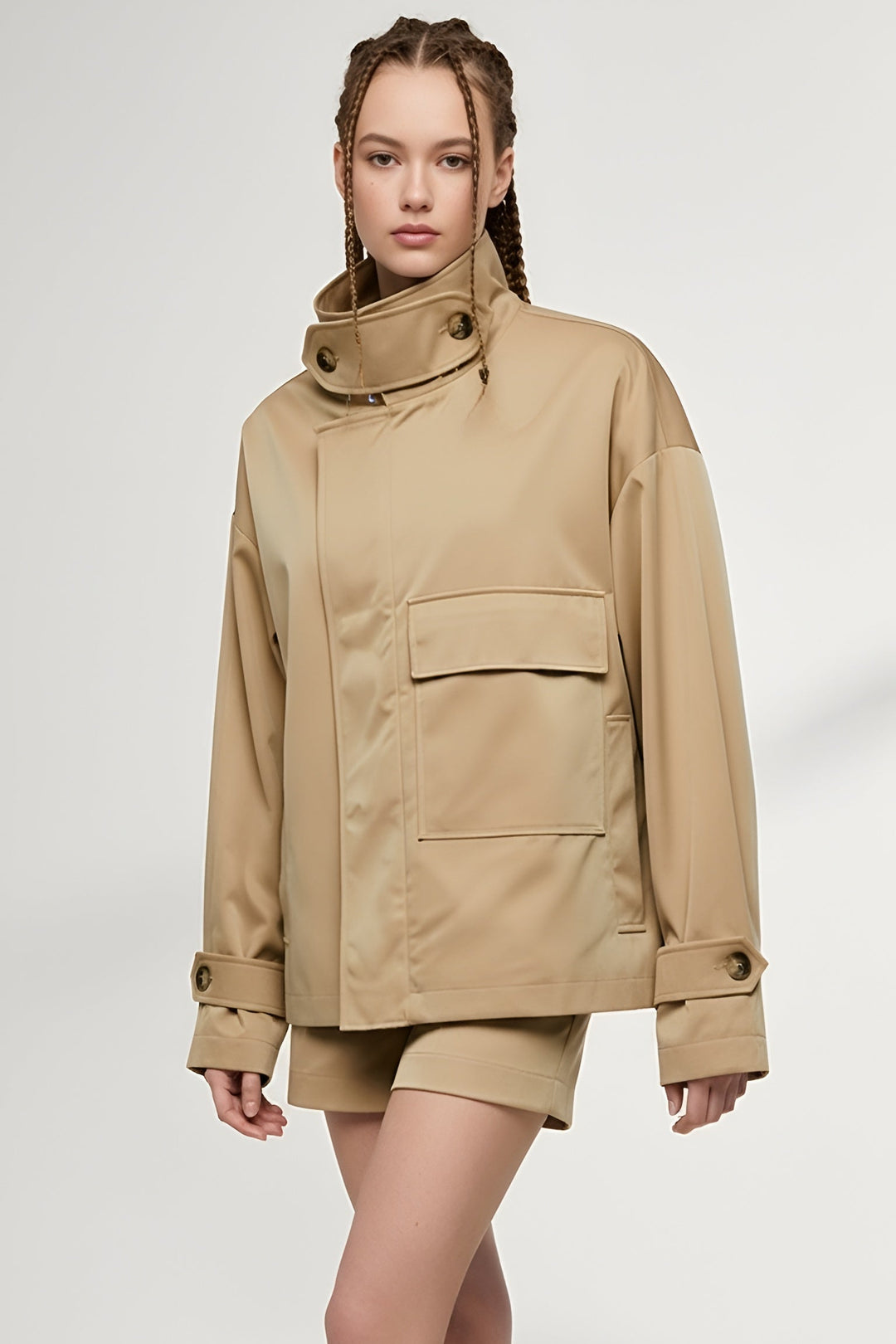 Model wearing ENVARA Glossy Cotton Coat in beige with stand collar and long waterproof design.