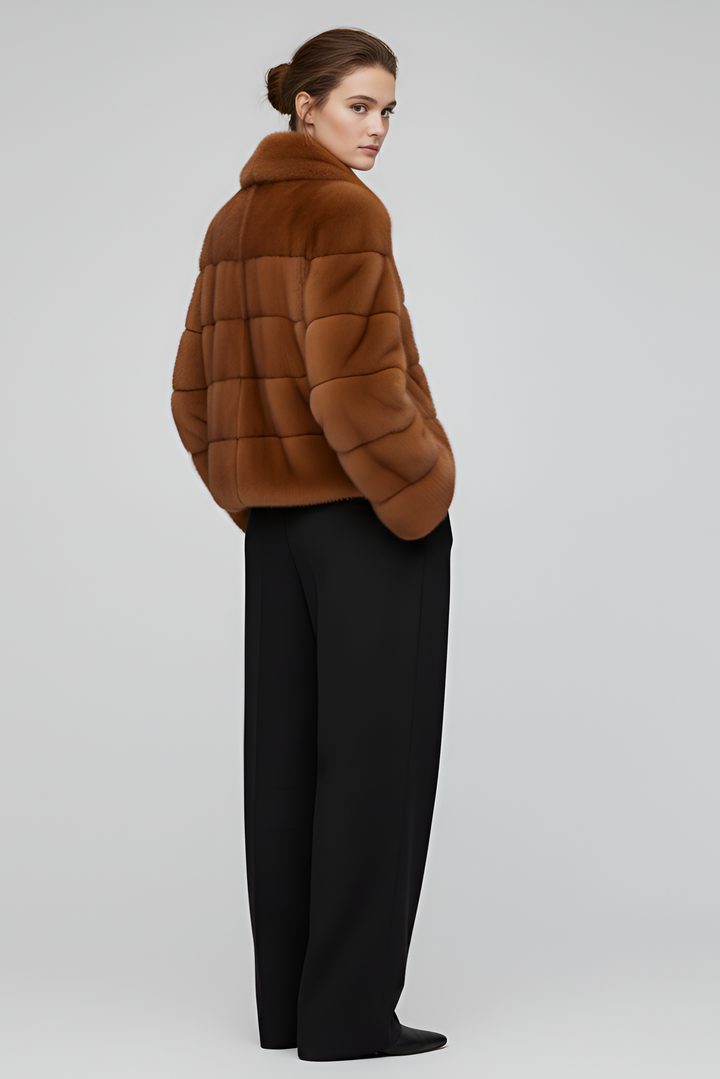 Model wearing the VELARIE faux fur coat in a winter outdoor setting.