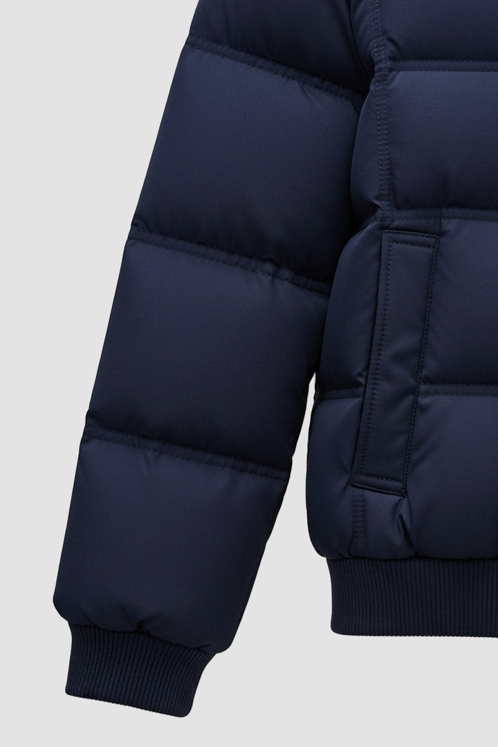Navy blue puffer jacket on a light gray background