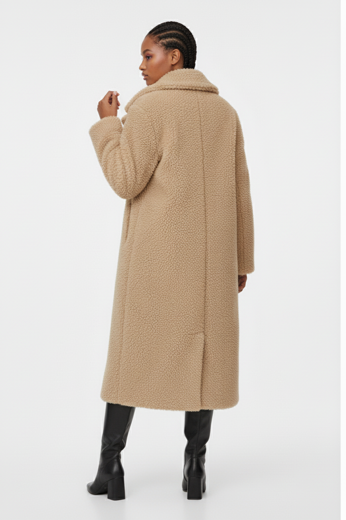 Person wearing a beige coat on a white background