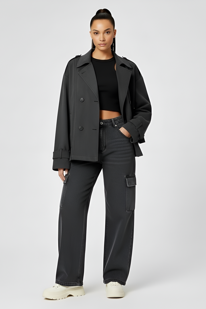 Person wearing a black coat and pants on a white background