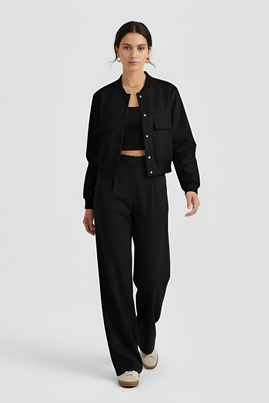 Person wearing a black outfit on a white background