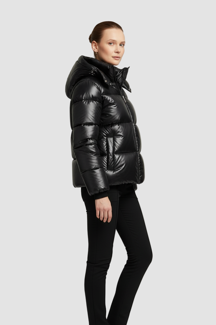 Person wearing a black puffer jacket on a light gray background