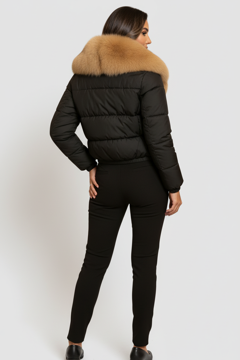 Person wearing a black puffer jacket with a fur-lined hood on a white background