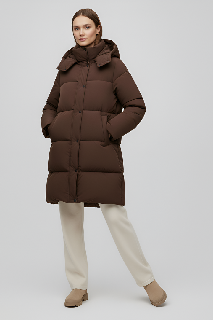 Person wearing a brown puffer coat on a white background