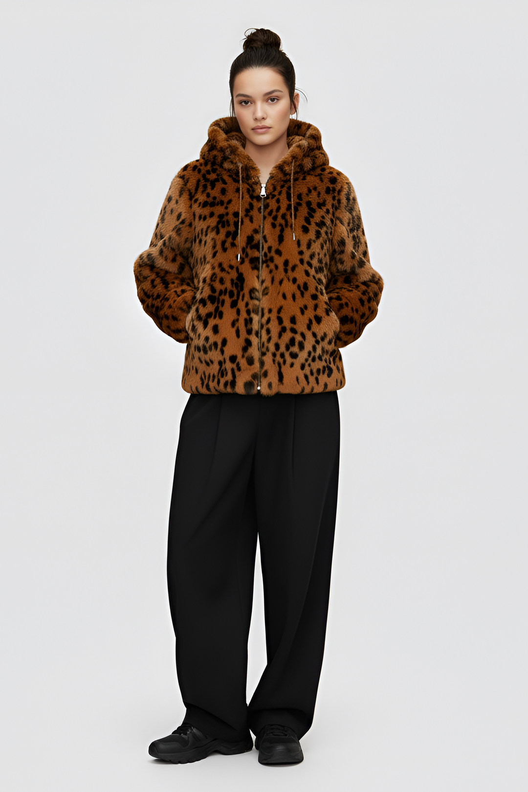 Person wearing a leopard print hoodie with a plain background