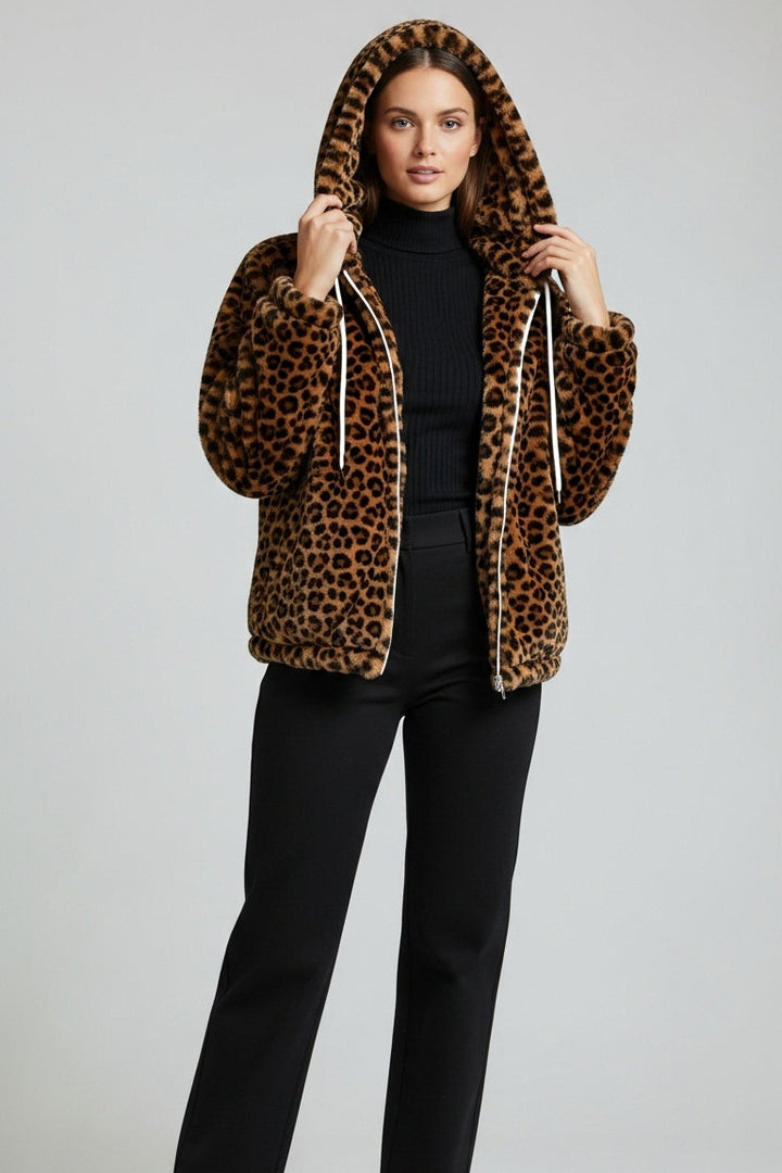 Person wearing a leopard print hoodie with a plain background