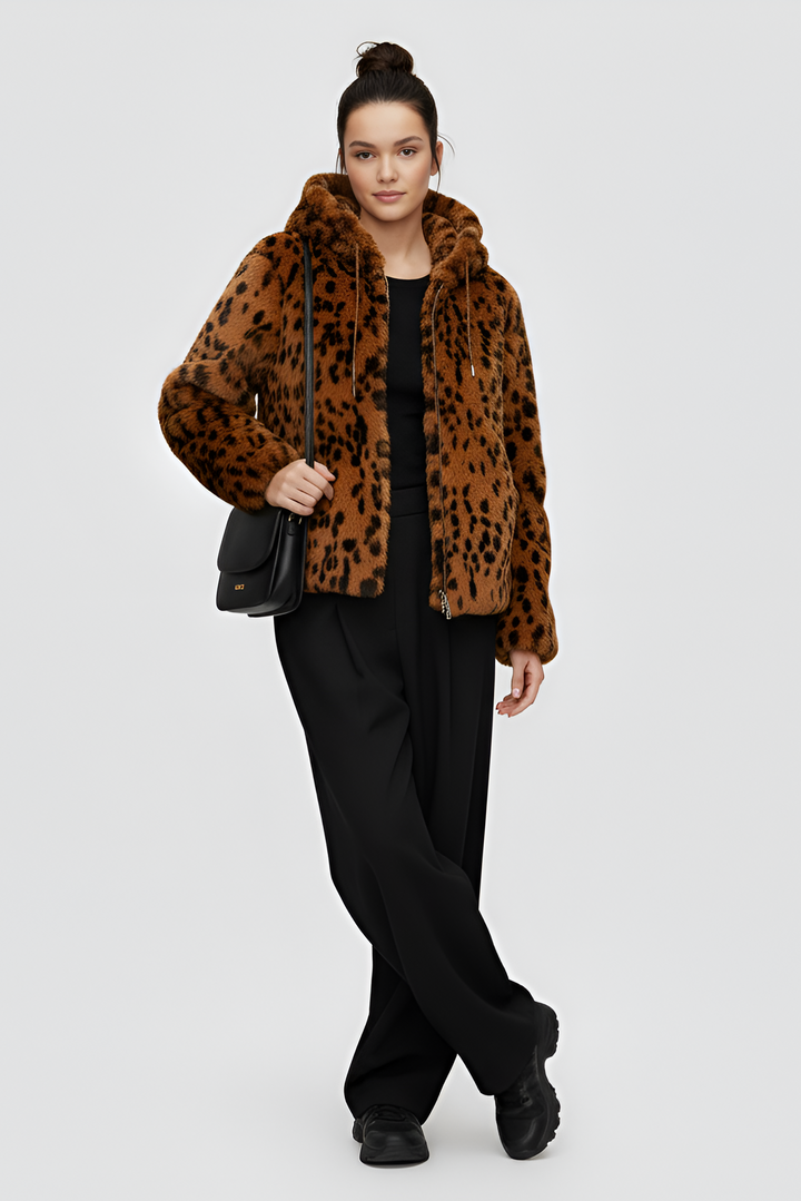 Person wearing a leopard print hoodie with a plain background