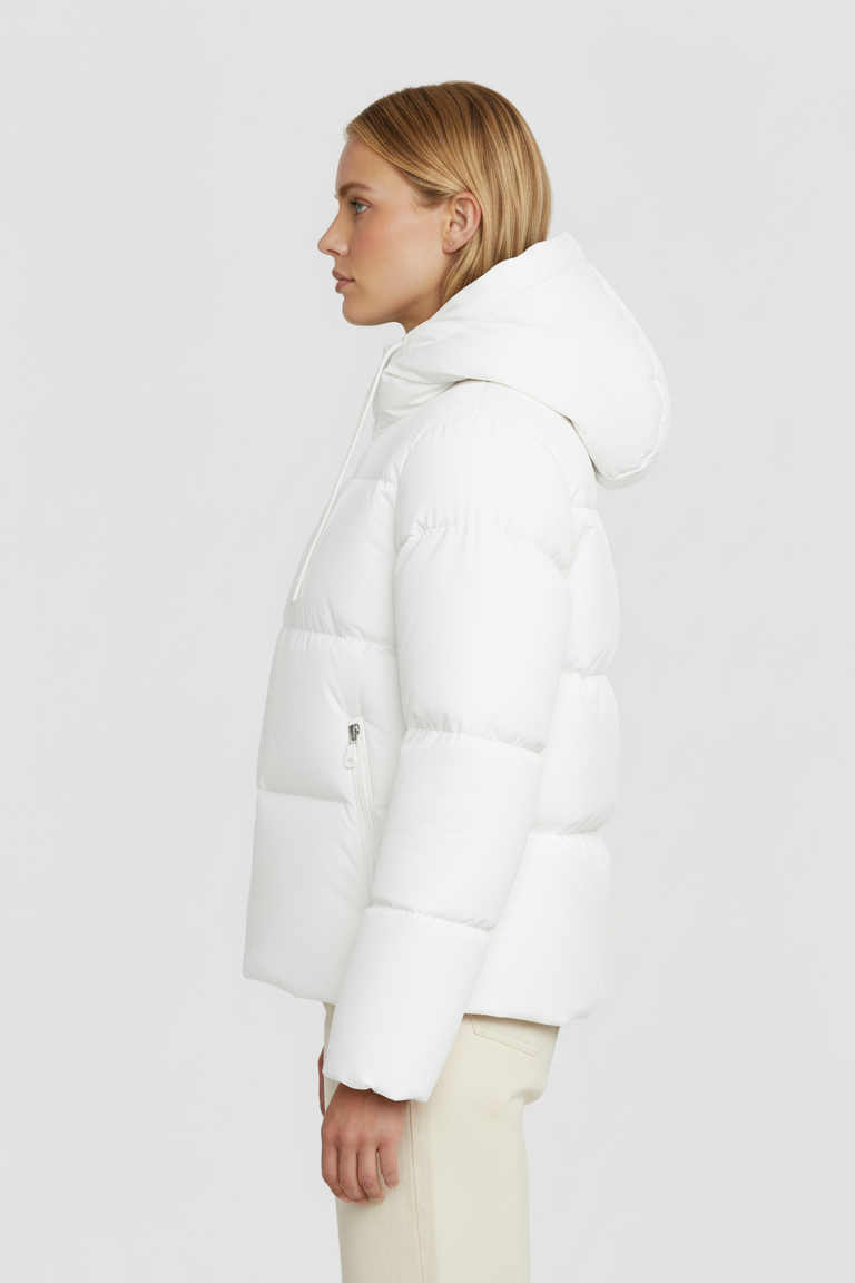 Person wearing a white puffer jacket on a plain background