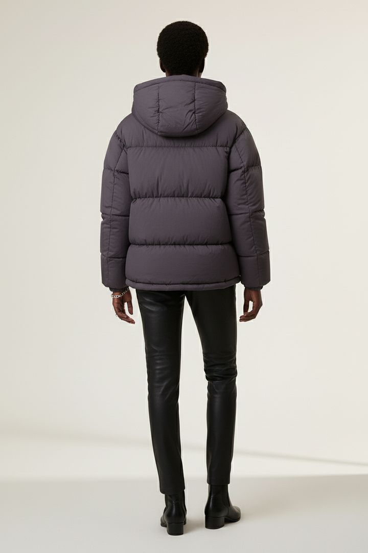 Portrait of model in LYORE Unisex Down Jacket, highlighting minimalist hood and refined details.