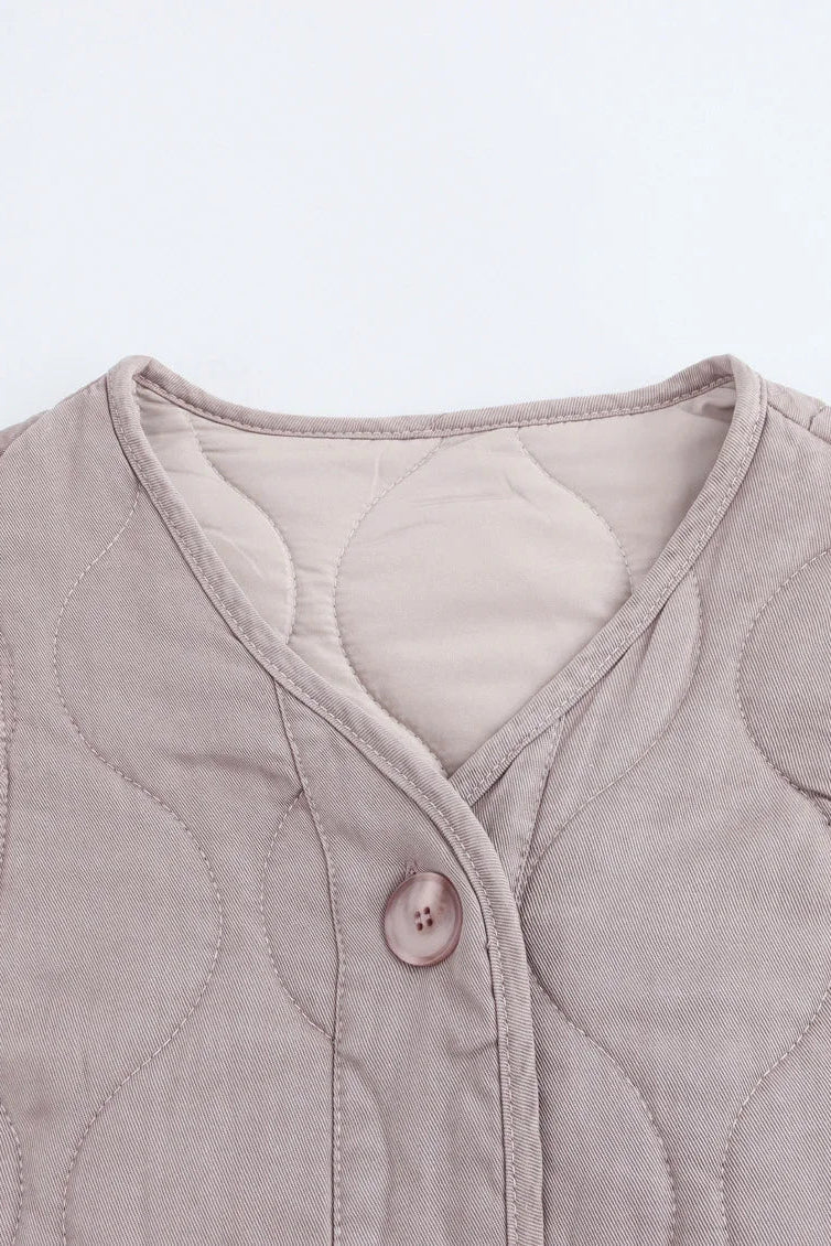 Quilted jacket with button detail on a light gray background