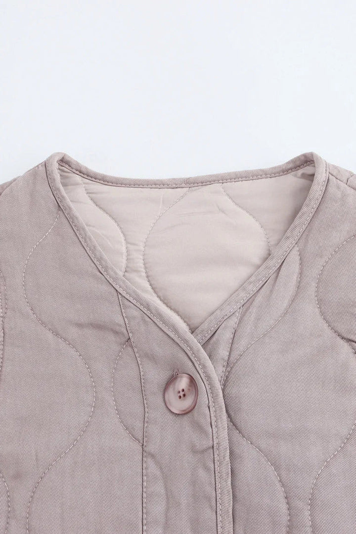 Quilted jacket with button detail on a light gray background