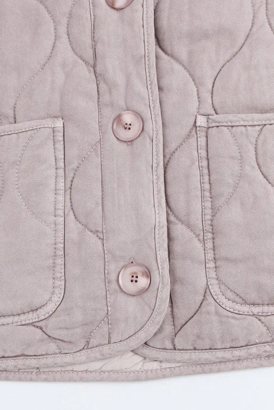 Quilted vest with button details on a white background