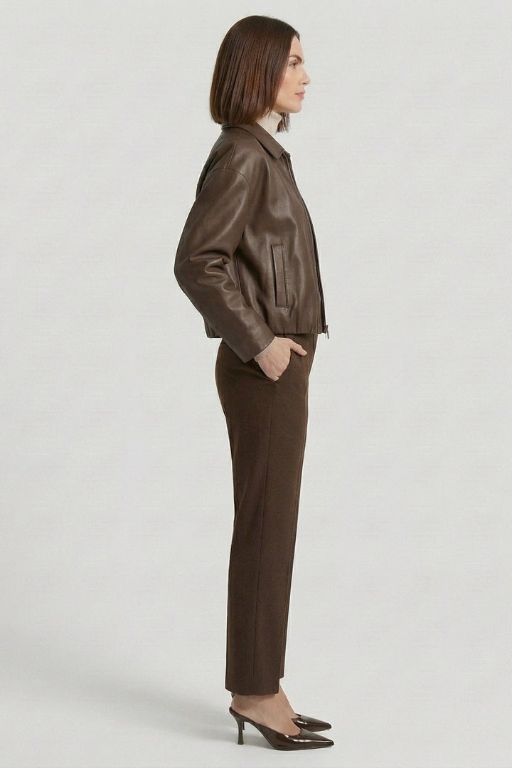 REESE - Side view, woman wearing brown leather jacket