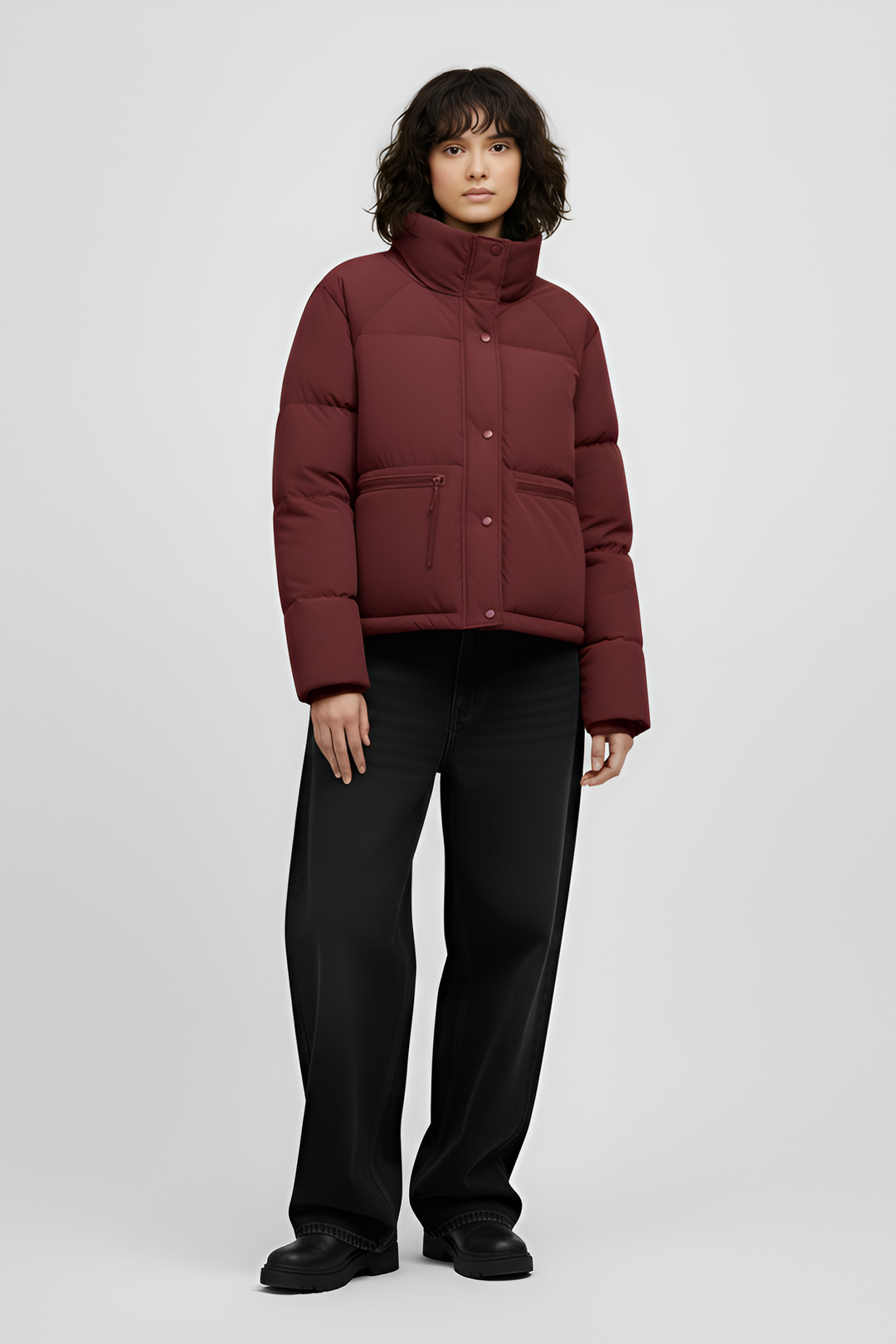 Woman wearing a red jacket and black jeans on a white background