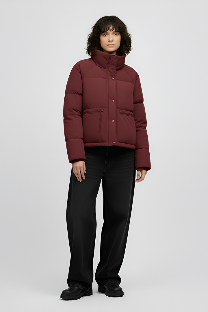 Woman wearing a red jacket and black jeans on a white background