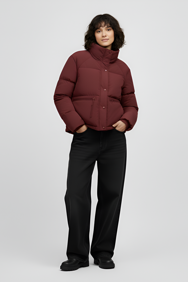 Woman wearing a red jacket and black jeans on a white background