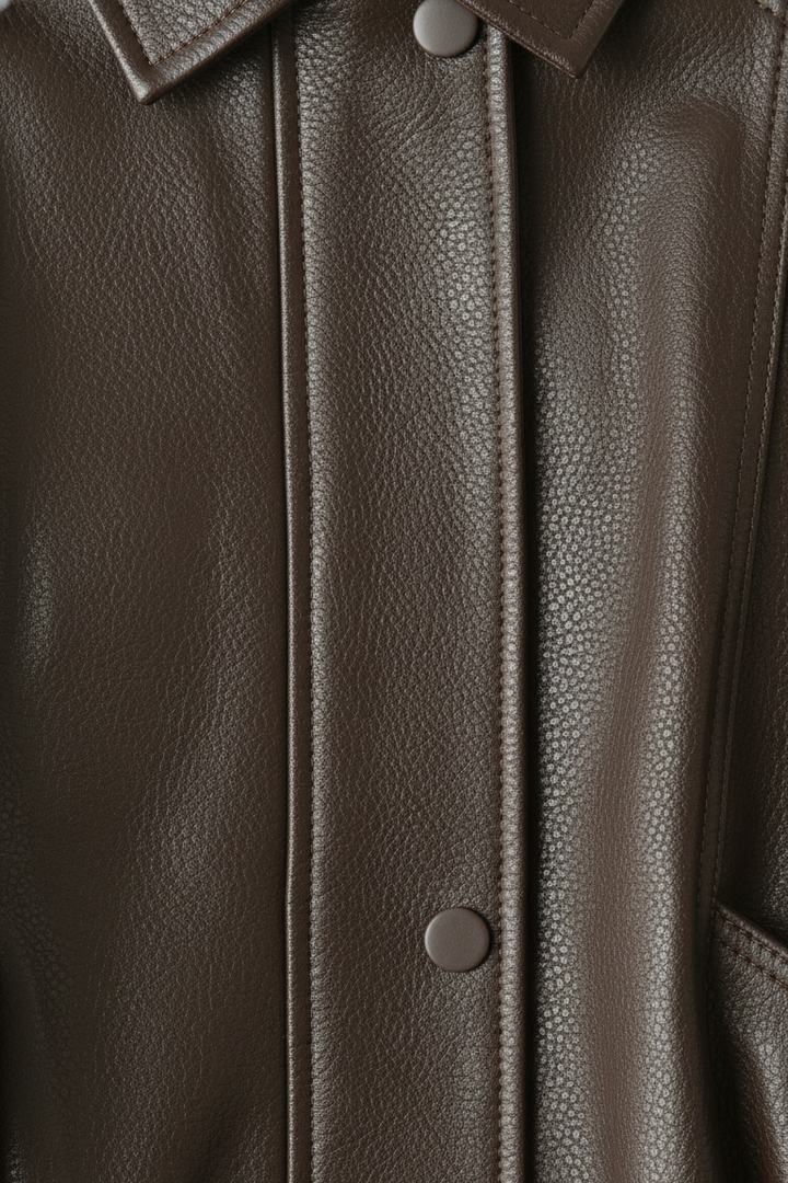 SCARLETT - Close-up of brown leather bomber jacket buttons