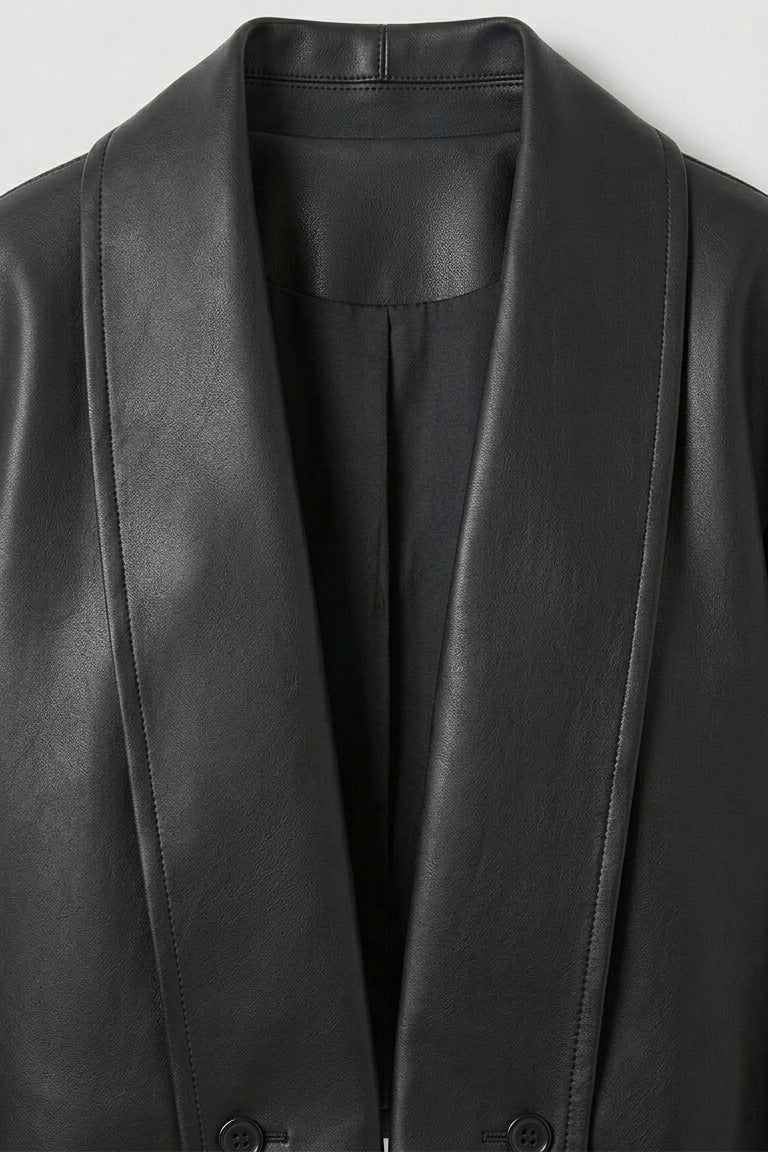 SYLVIANE - Close-up of a black leather jacket font closure on a light gray background