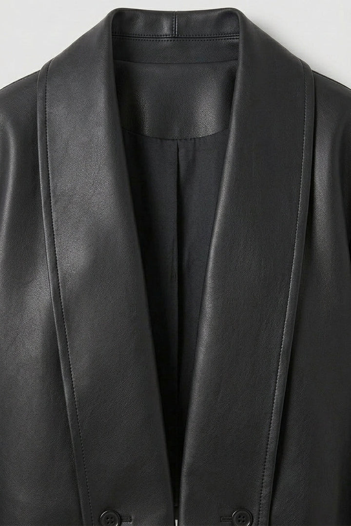 SYLVIANE - Close-up of a black leather jacket font closure on a light gray background