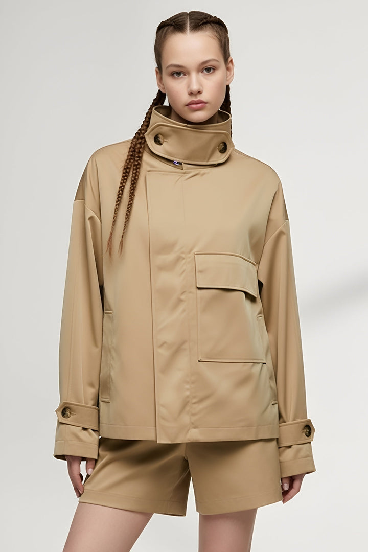 Side angle of ENVARA long women’s trench coat in camel with full-length sleeves and pockets.